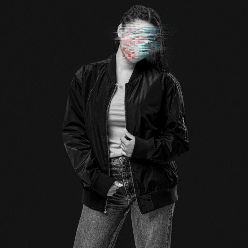 Woman wearing a black bomber jacket made of recycling polyester, her face is made unrecognizable through colorful glitches