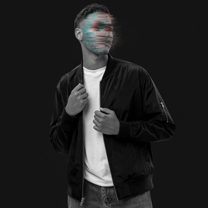 Man wearing a black bomber jacket made of recycling polyester, his face is made unrecognisable with glitches