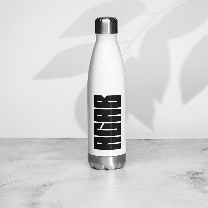 White bottle with a black 'ACAB' print on it, which stands for 'All Cops Are Bastards', with brushed steel lid and bottom, standing on a marvel plate