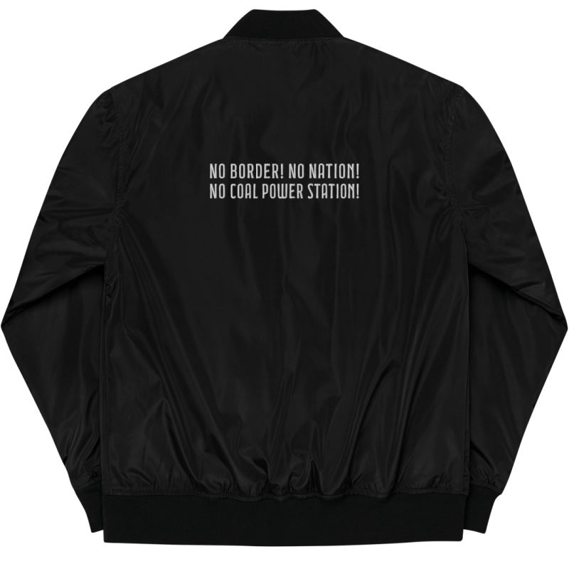 Backside of a black bomber jacket supporting antifascist climate activists, made of recycling polyester, on the upper back of the bomber jacket, there is a white embroidery saying 'No border! No nation! No coal power station!'