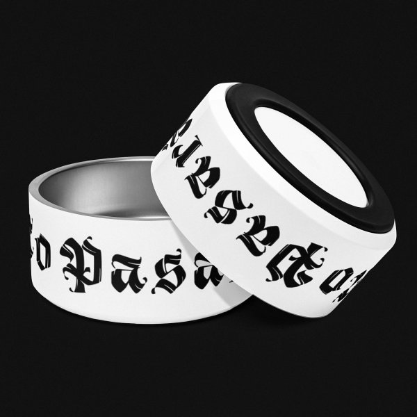 Two white petbowls with the black words 'no pasáran' printed on, one is upside down, leaning against the other