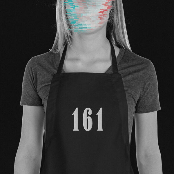 Blonde woman wearing an antifascist apron with an embroidery saying '161', short for 'antifascist action', her face is hidden behind glitches