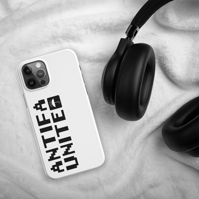 Back of an iPhone with a white phone case, located on a textile surface, the case is saying 'antifa unite' in black letters, with a little icon showing an umbrella under water droplets, white on black square with rounded corners, black headphones are next to the iPhone on the right